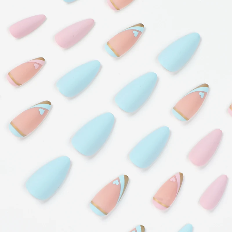 Kunstvolle Stiletto-Nägel mit Goldakzenten und Herz-Design Karnz