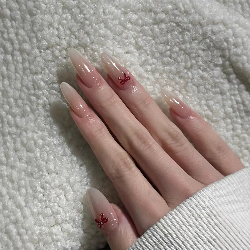Elegante Stiletto Press-On Nägel mit dekorativen Schleifenakzenten Karnz